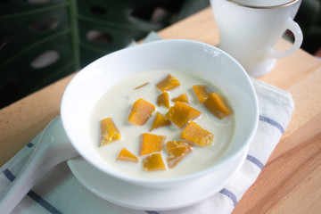 Thai dessert: Pumpkin in sweet coconut milk,  Coconut Milk Stewed Pumpkin bowl. (Buak Phak Tong)