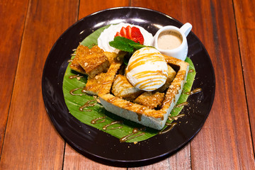 Honey toast with ice cream and syrup.