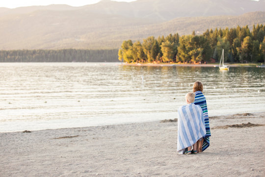 Young boy and girl looking off into distance at Whitefish Lake in Montana