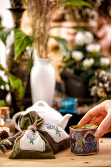 Still life with beautiful decorative jars and bags. Dried flowers and pussy-willow twigs in the background.