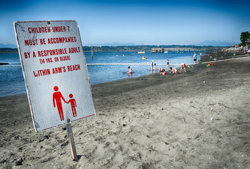 Sign at beach explains the safety rules for parents and children to follow