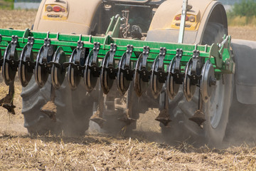 Tractor cultivating the field