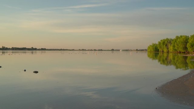 Early morning on an empty swimming beach in Boyd Lake State Park in northern Colorado, panning