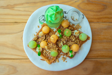 Waffle with cantaloup and melon soft cream, topping with alomnd and grains, healthy dessert
