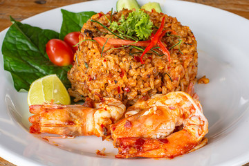 Fried rice with Shrimp on wooden table , spicy food Thai style.