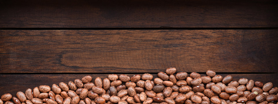 Pile of pinto beans on wooden background