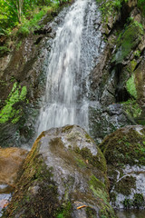 Fototapeta premium Nice waterfall from front with big stones, Novohradske mountain, Czech republic