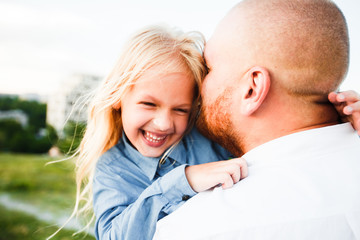 Fototapeta premium Happy father and child spending time outdoors. Beautiful blonde daughter.