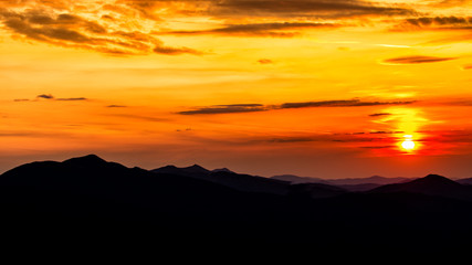 Stunning sunset in the mountains. Orange sky and mountains silhouettes. Carpathian Mountains. Bieszczady. Poland