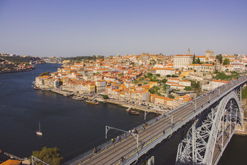 Porto, Portugal - 10/20/2019: Famous Porto bridge Ponte Luis top view. Porto bridge over river Douro. Portuguese river Douro with metro bridge and tourists. Porto landmark on sunny day. Summer travel.