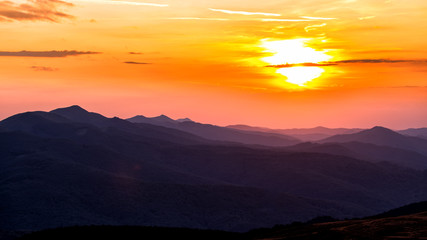 Fototapeta na wymiar Stunning sunset in the mountains. Orange sky and mountains silhouettes. Carpathian Mountains. Bieszczady. Poland