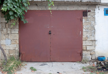 old metal door to the car garage