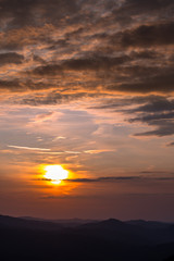 Stunning sunset in the mountains. Orange sky and mountains silhouettes. Carpathian Mountains. Bieszczady. Poland