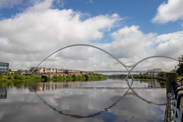 Fototapeta na wymiar The famous Infinity Bridge located in Stockton-on-Tees taken on a bright sunny part cloudy day.