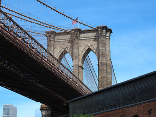 Fototapeta premium New York, NY, USA. Views of the Brooklyn bridge from the historic and trendy Dumbo neighborhood. Wonderful summer day. Holiday time
