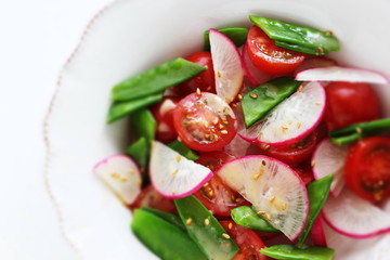 Vegetarian salad, radish and tomato sesame salad