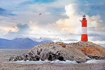 Panormaic view of the Les Eclaireurs Lighthouse, on the Beagle Channel in Ushuaia, Tierra del Fuego, surrounded by a warm sunset sky.