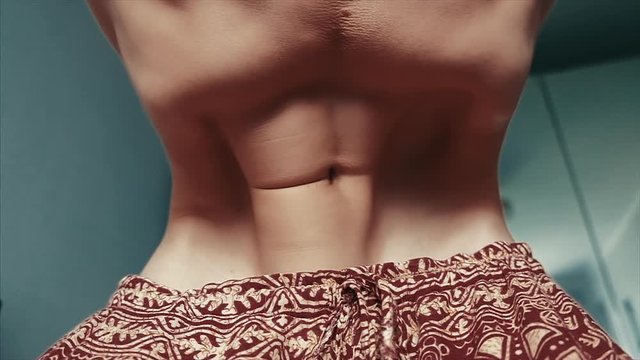 Young man does Nauli Kriya exercise. Loopable seamless footage at natural speed
