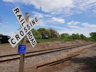Close up of a crossing sign at a railroad track