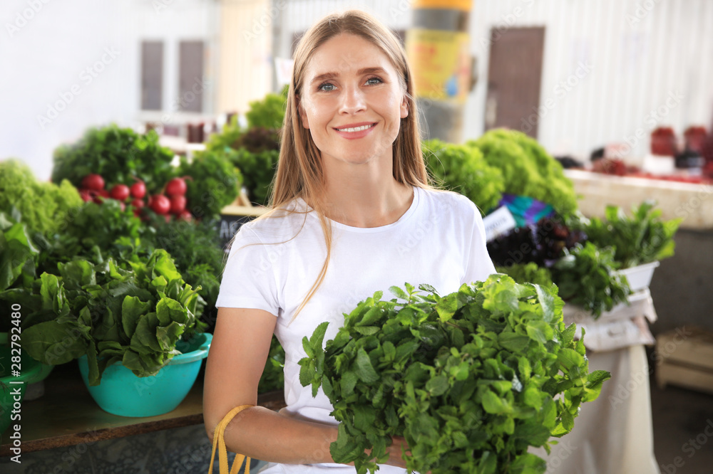 Wall mural Woman with fresh mint at market