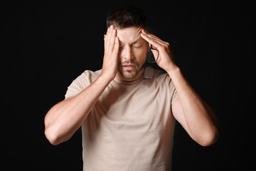 Fototapeta premium Stressed man on dark background
