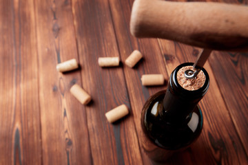 Obraz na płótnie Canvas Corkscrew and bottle of wine on the board - Image