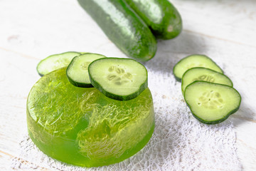 Sliced cucumber and soap on a white background. Home body care cucumber and care concept.