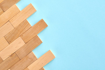 Brown wooden blocks idea on blue background composition.