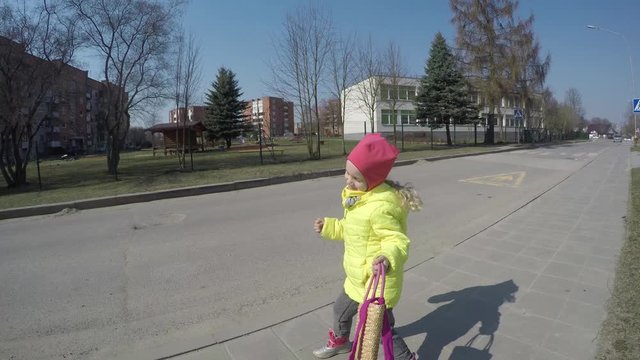 playful model girl pose with handbag. Cute toddler child simper. Gimbal shot
