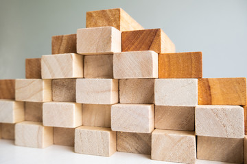 Wood block tower with architecture model, Concept Risk of management and strategy plan, growth business success process and team work