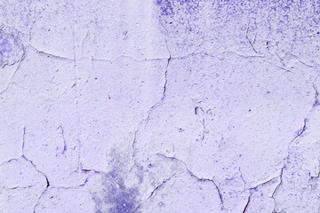 Old purple color wall with cracks close up. Abstract background