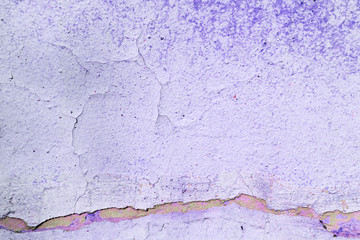 Old purple color wall with cracks close up. Abstract background