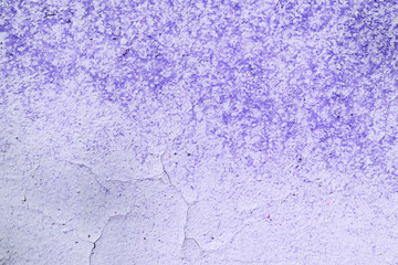 Old purple color wall with cracks close up. Abstract background