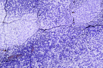 Old purple color wall with cracks close up. Abstract background