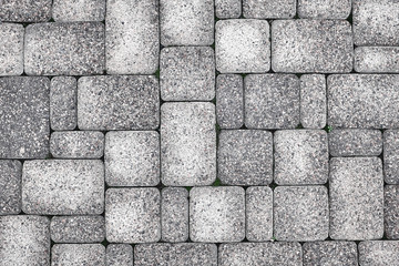 Stone pavement texture wet after rain. The texture of the road surface.