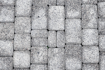 Stone pavement texture wet after rain. The texture of the road surface.