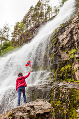 Tourist woman at waterfall Svandalsfossen, Norway