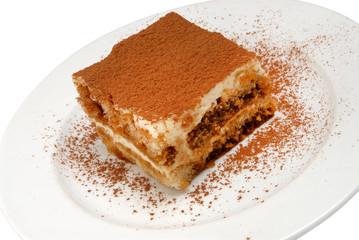 Slice of delicious cake on a white plate on white isolated background