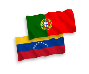 National vector fabric wave flags of Venezuela and Portugal isolated on white background. 1 to 2 proportion.