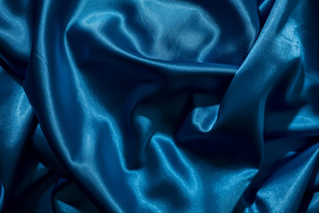 Background image of crumpled fabric. Blue silk