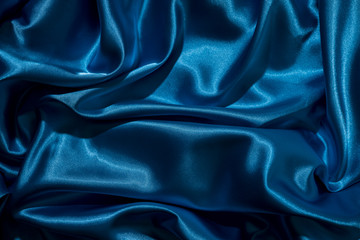 Background image of crumpled fabric. Blue silk