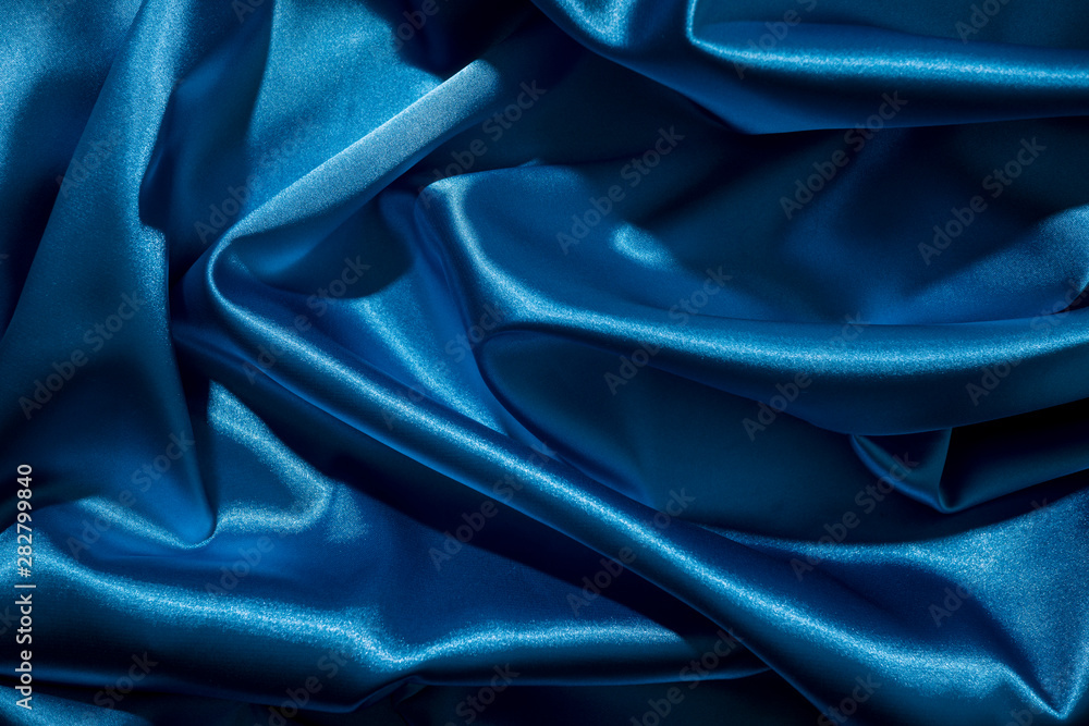 Wall mural background image of crumpled fabric. blue silk