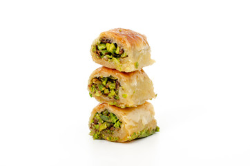 Baklava with pistachios and honey on white background, turkish, arabic traditional national dessert. Macro, selective focus.