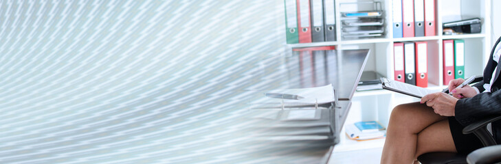 Businesswoman taking notes; panoramic banner