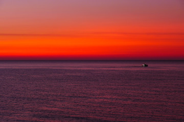 Syracuse, Sicily, Italy A fishing boat at dawn on the Mediterranean Sea.