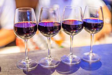 Many glasses of different wine on bar counter