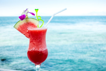 Watermelon cocktail on blue tropical summer sea.