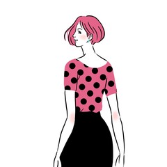 オフィスにいるドット柄の洋服を着た若い女性