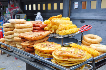 Background of varieties of fried foods on a street food in Vietnam and Asian countries make with pork, chicken, and seafood.   