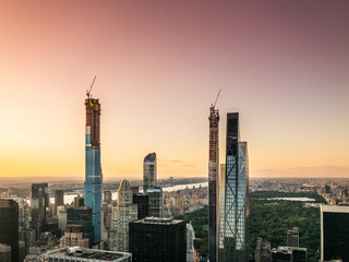 Tall construction buildings in New york in colorful sunset
